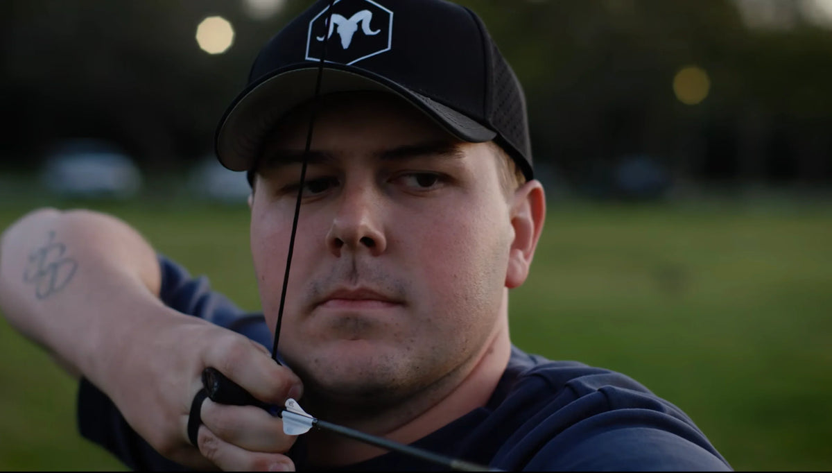 Target archery shooter wearing a RamRods hat while shooting with SPECTRA sight.