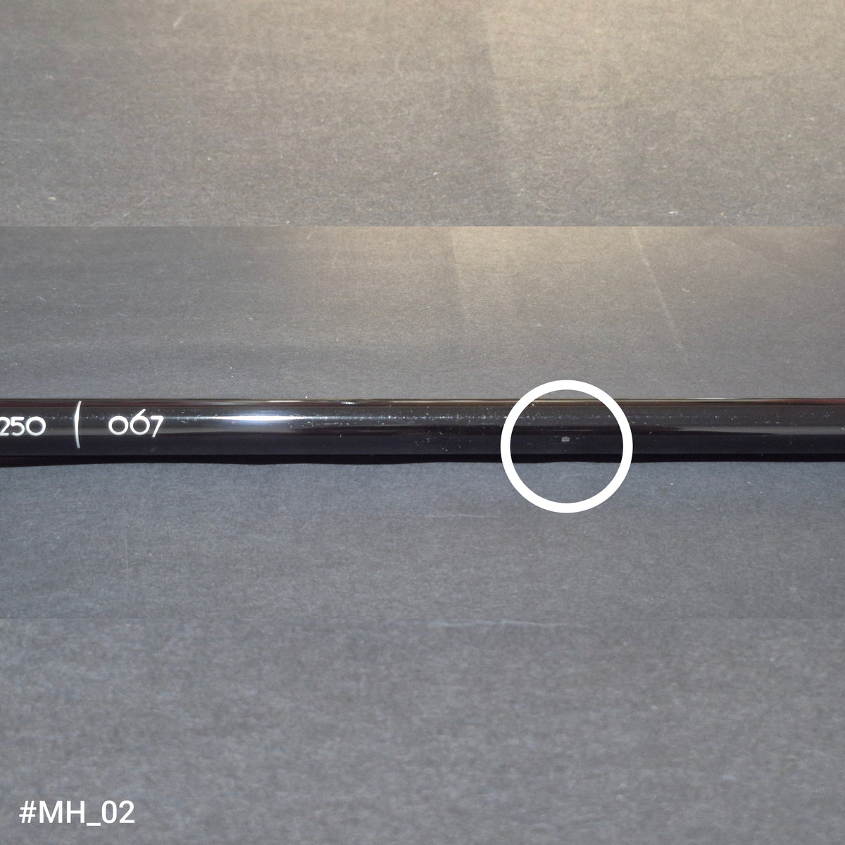 A discounted RamRods Matterhorn archery stabilizer, tungsten damping, 30 inch. A chip in the shaft surface is circled in white.